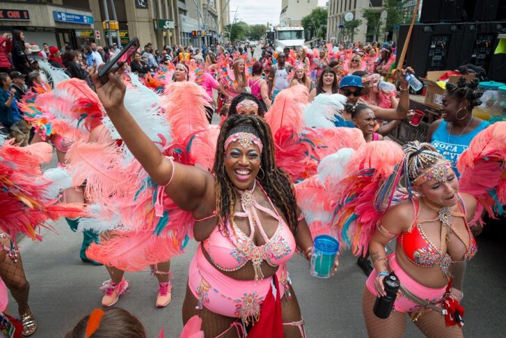 Cariwest Festival ladies dancing on Jasper Avenue parade