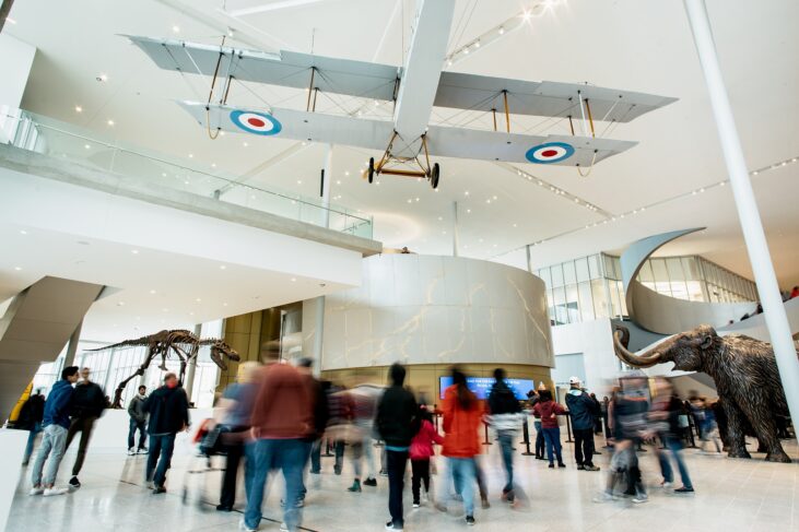 Crowd of people walking around the mainfloor lobby of the Royal Alberta Museum