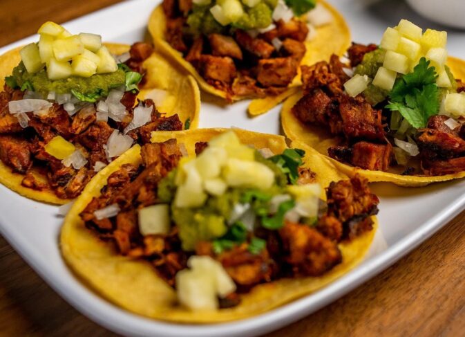A plate of four tacos el pasteur