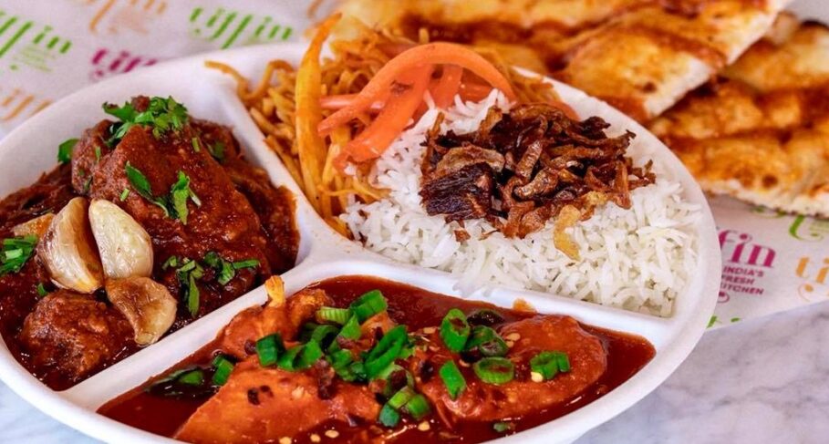 Plate of butter chicken, rice and vindaloo from Tiffin